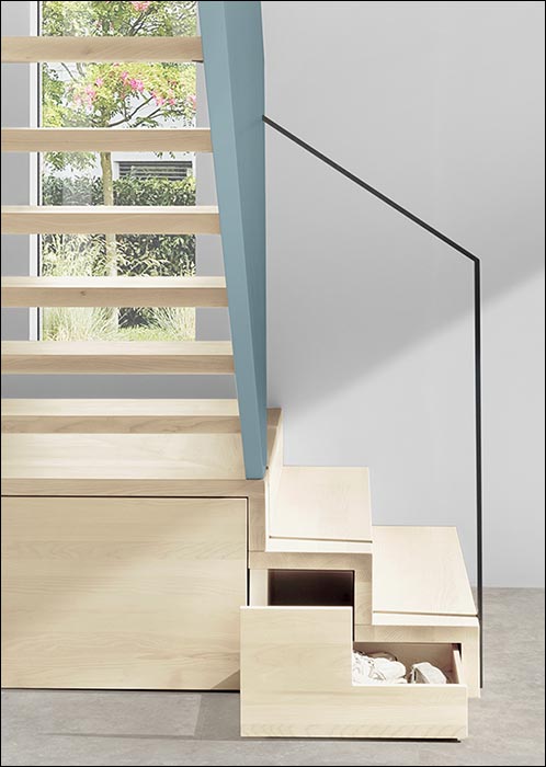 Holztreppe mit Schubkästen im Podest und mittragendem Geländer aus durchgängiger Holzplatte